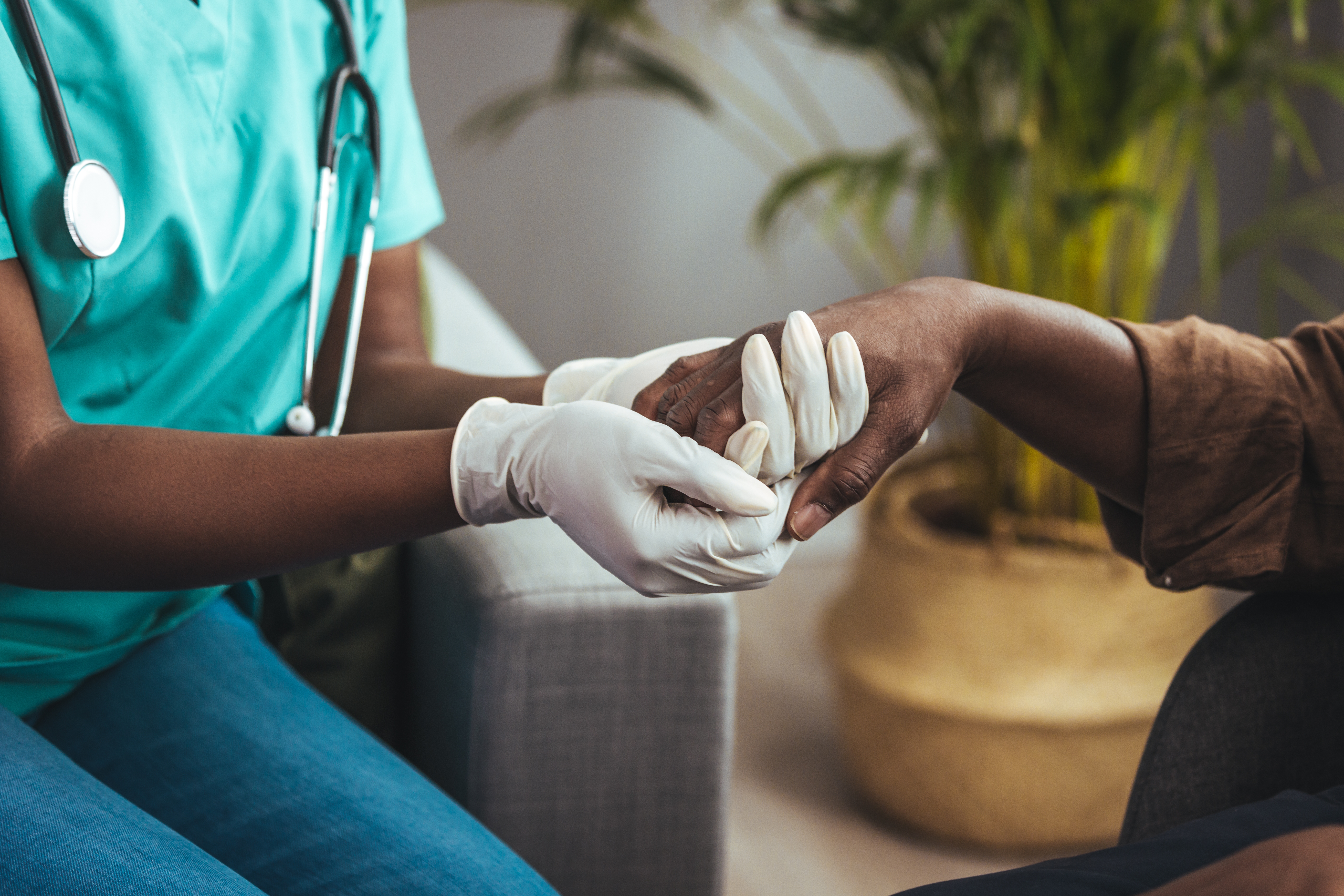 Caring,Nurse,In,White,Coat,Holding,Hands,Of,Old,Man